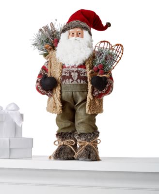 Holiday Lane - 18"H Fabric Standing Santa in Reindeer Sweater and Plush Vest with Gift Bag